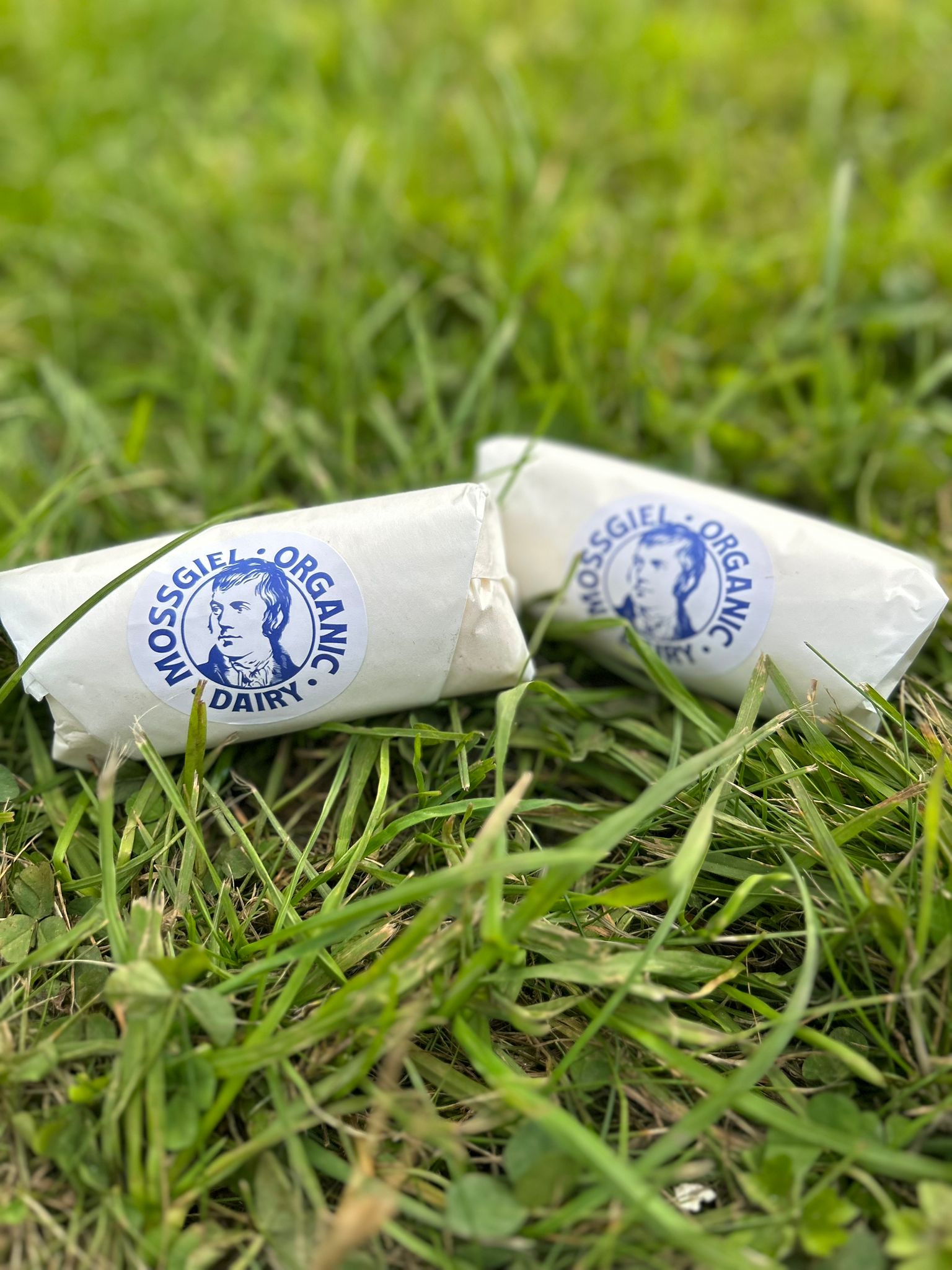 Mossgiel organic butter wrapped in paper on green grass