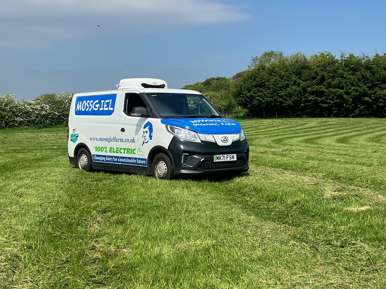 Mossgiel electric delivery van parked in a grass field